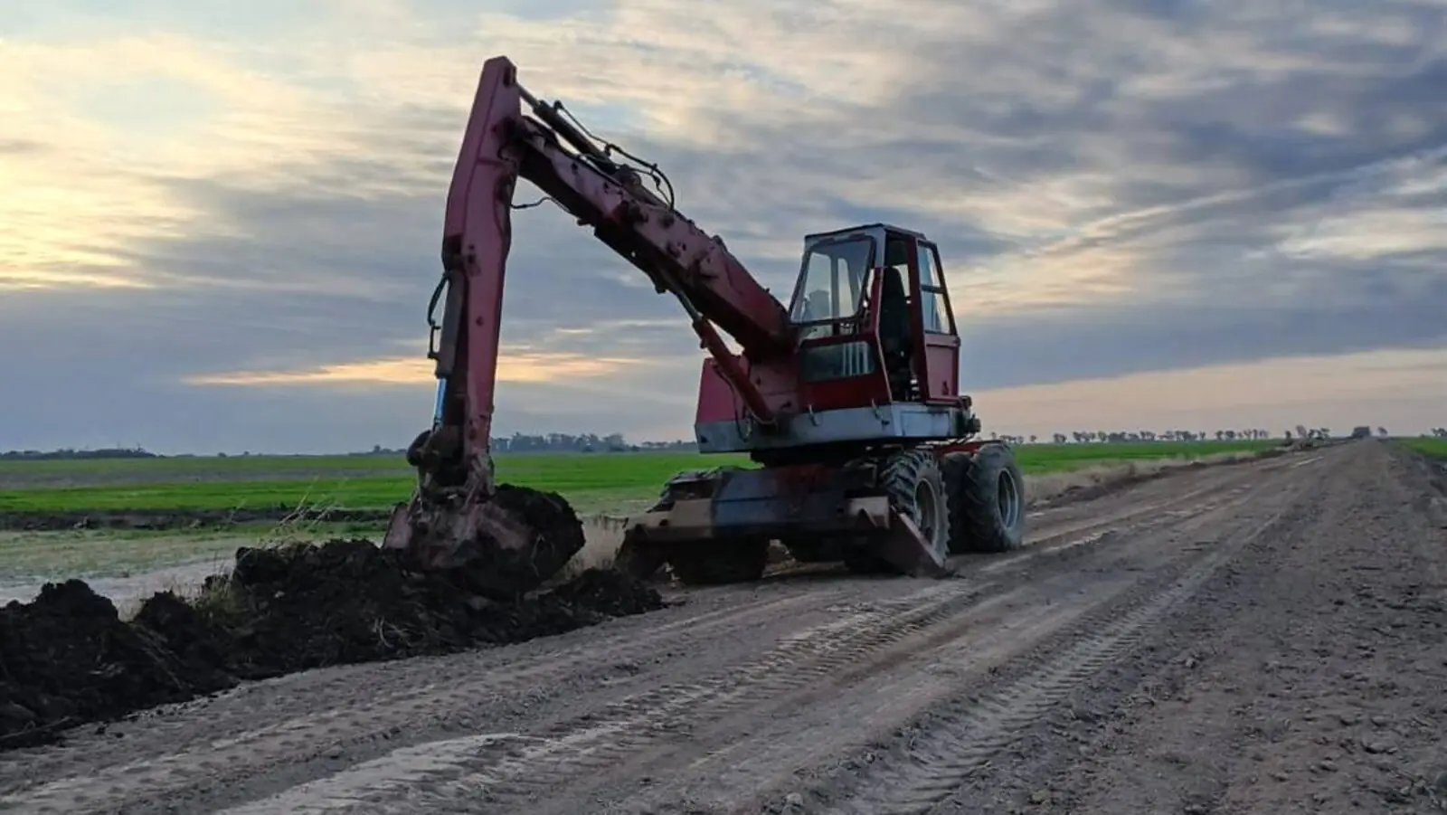 Excavadora de Hidra Dock abriendo una cuneta al costado de un camino rural